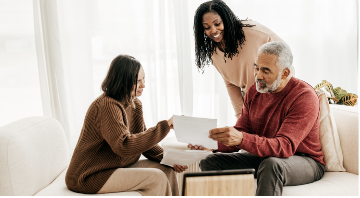 Family meeting happily discussing homeownership equity that they currently discover on their home